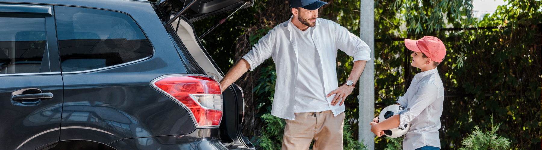 Auto insurance represented by a man and son standing by vehicle